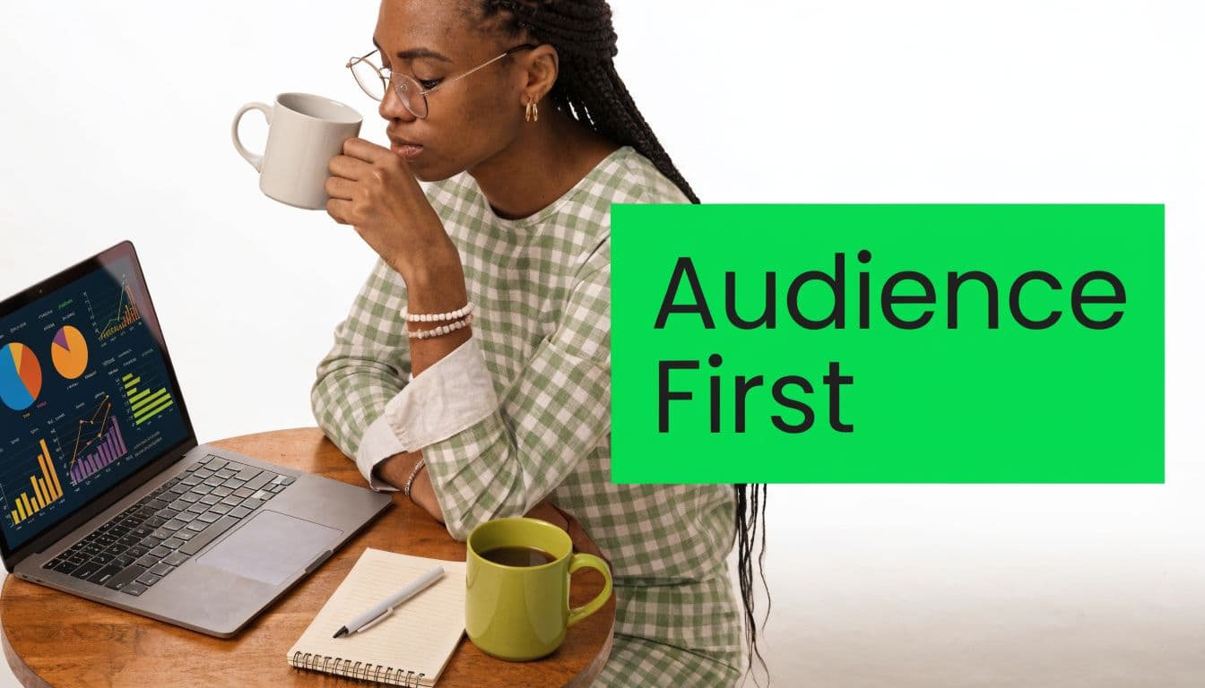 A woman in a plaid top drinking coffee while analyzing marketing data charts on her laptop screen.