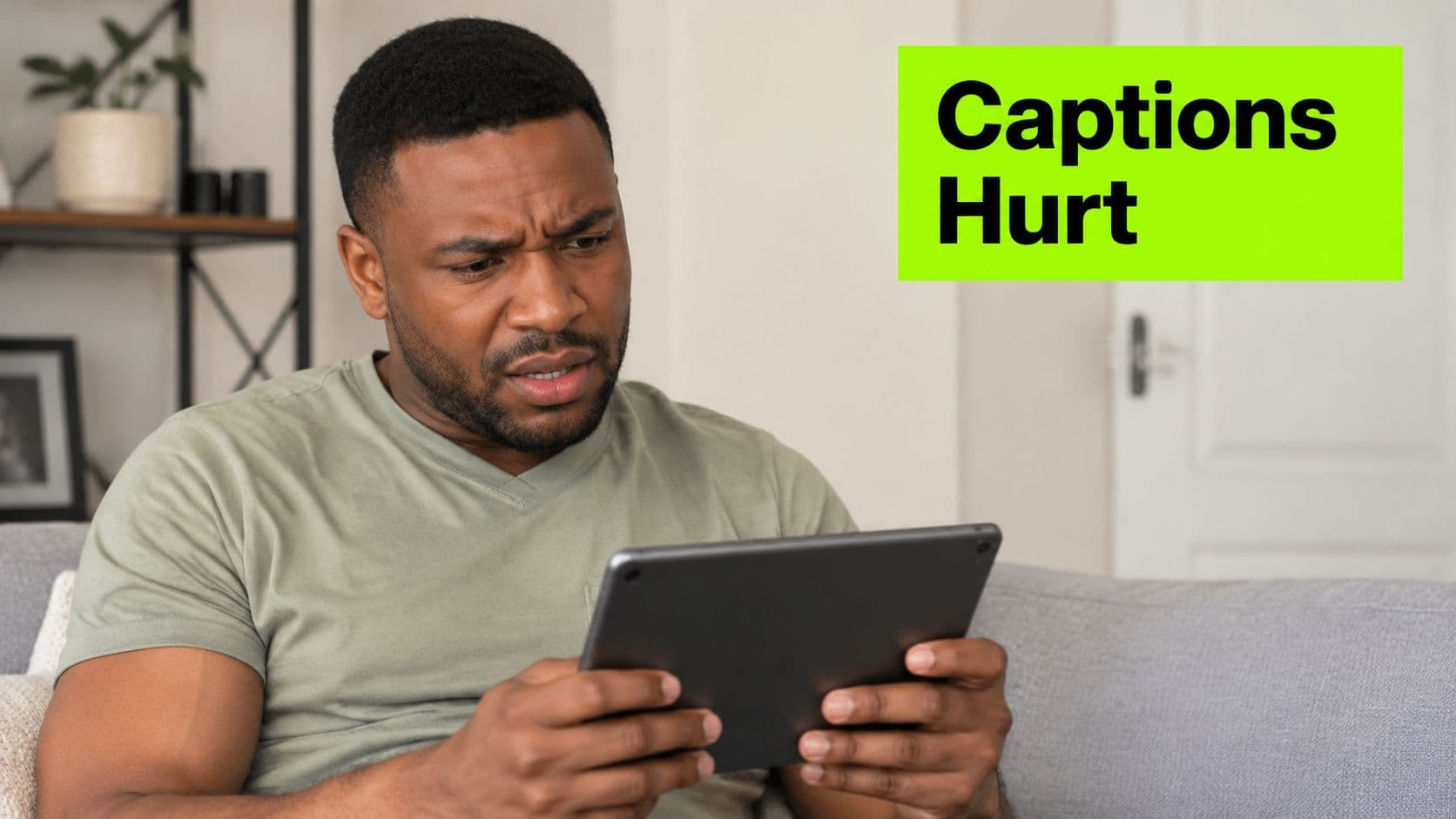 A man looking at a tablet with a concerned and frustrated expression, overlayed with the text Captions Hurt.