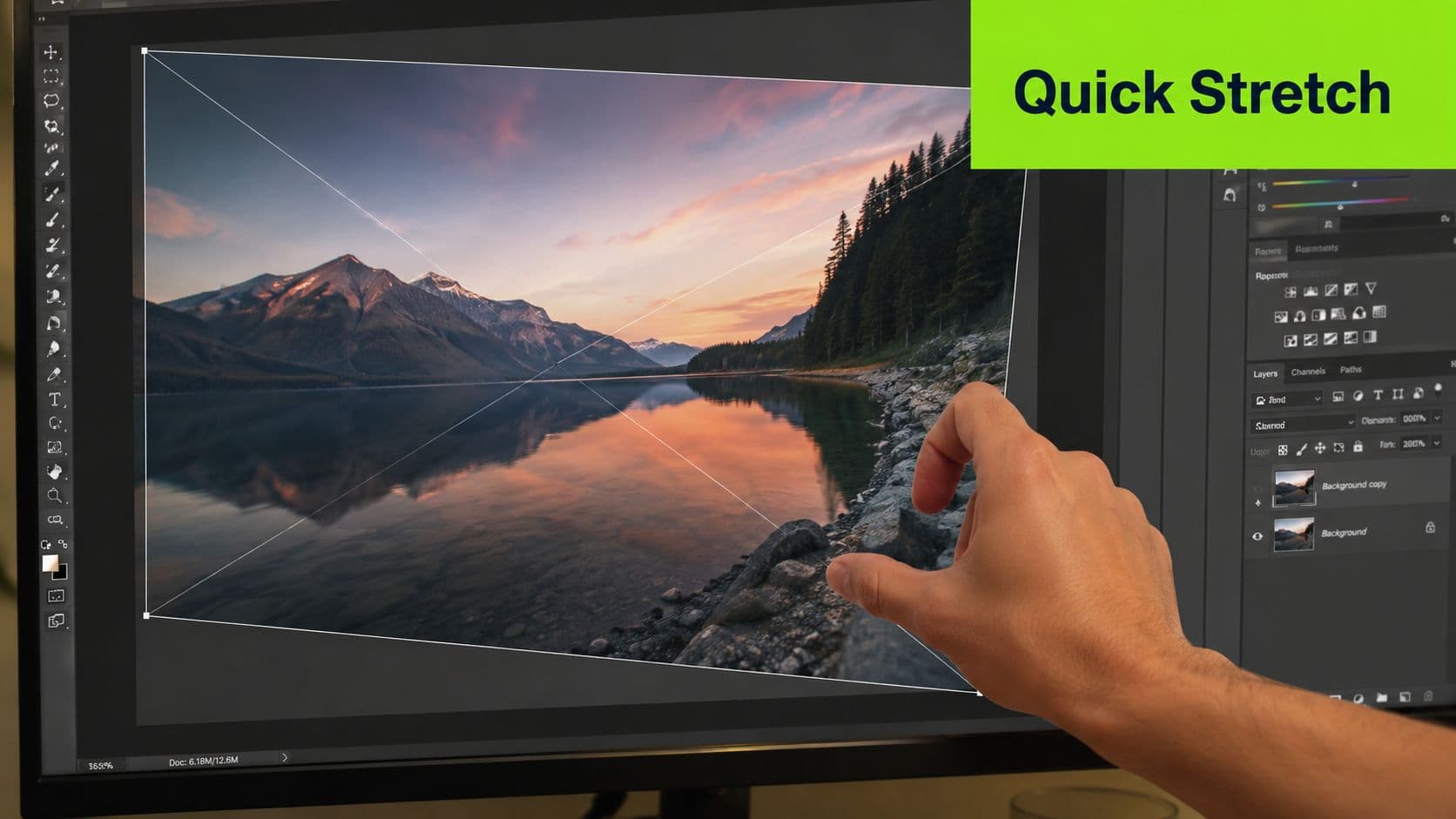 A close-up view of a hand using a computer screen to stretch an image in Photoshop.